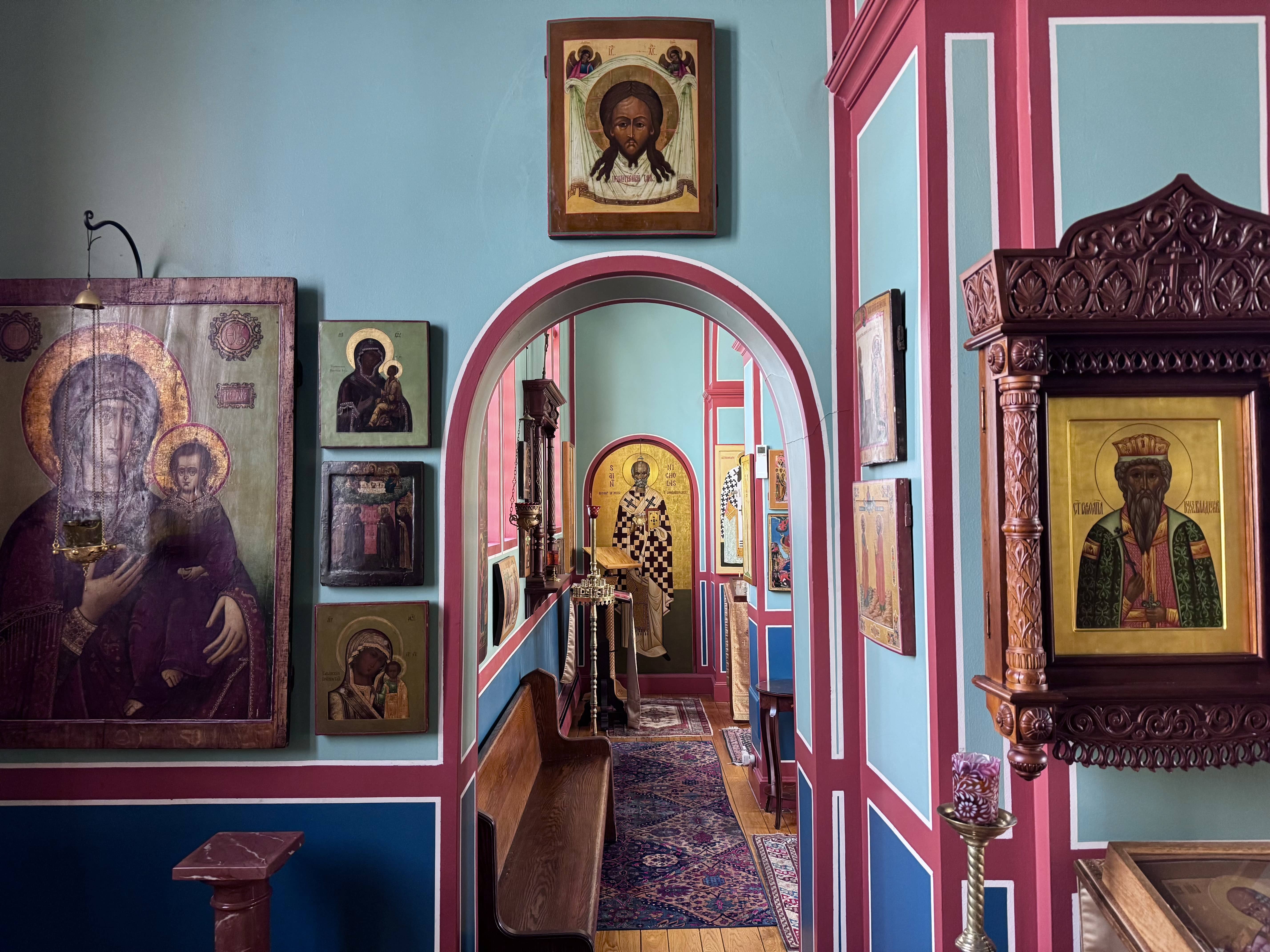 Looking down the hallway near the church entrance towards the full-height icon of St. Nicholas